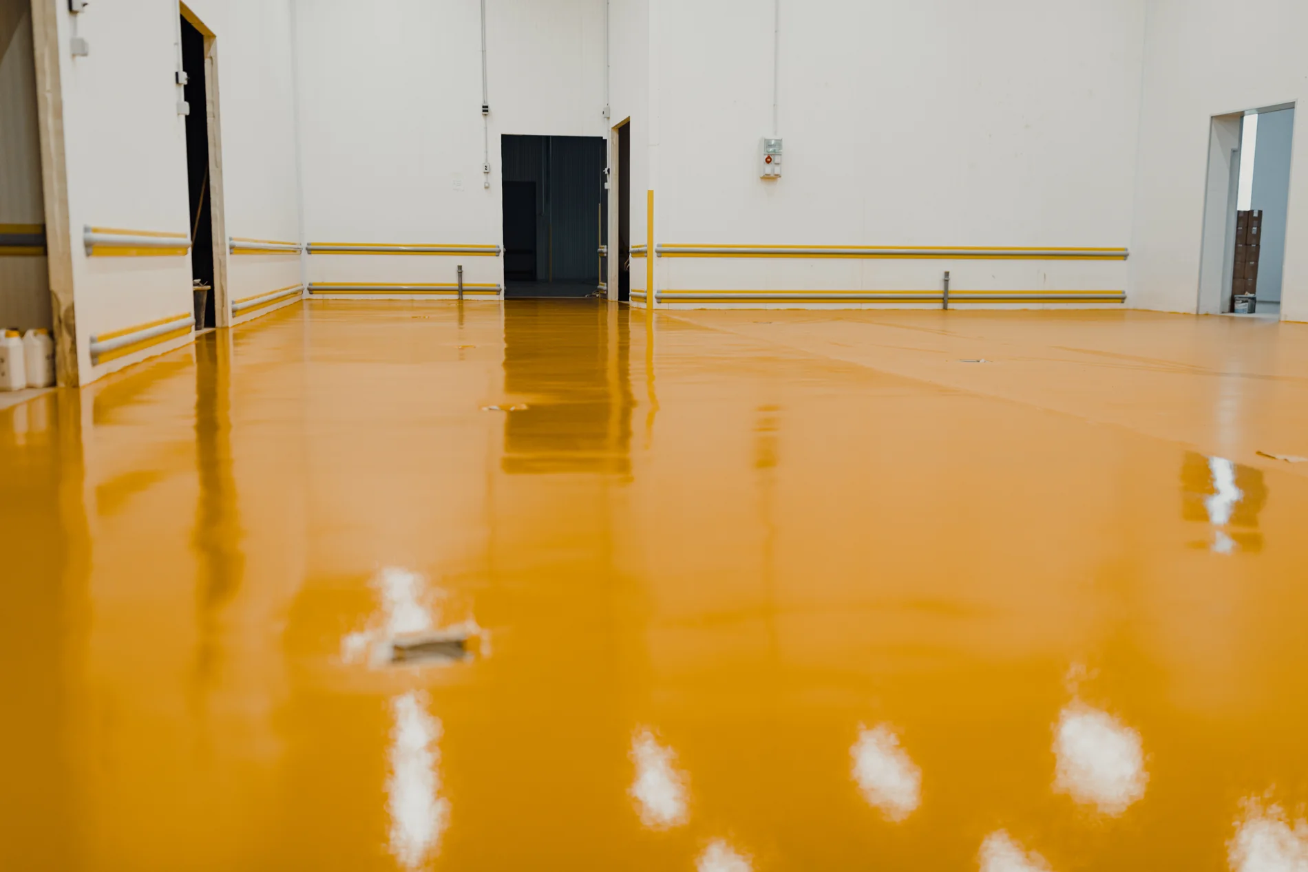 Finished golden yellow resin floor in an industrial interior, an illustrative stock photograph